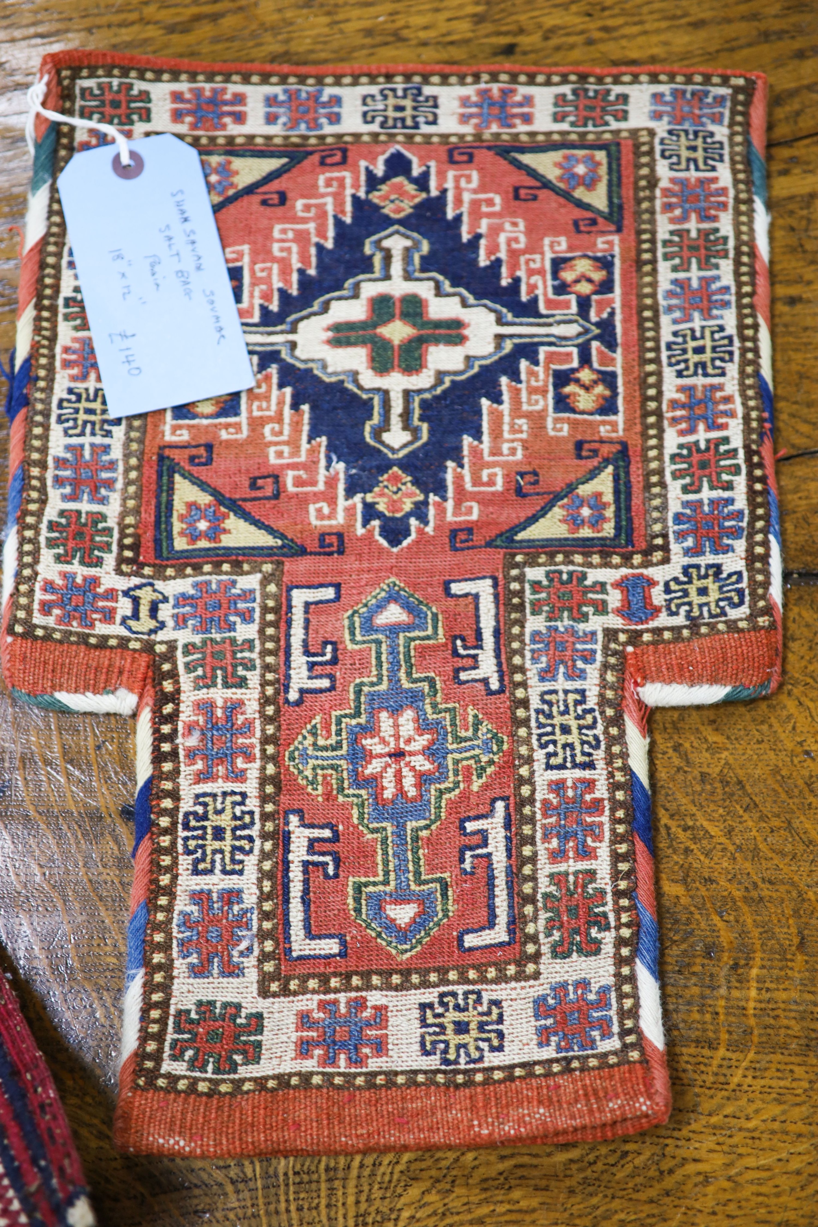 A Shah Savan Soumac salt bag, 45 x 31cm. a near pair of Soumac cushions, 34 x 34cm. and a fragment, 50 x 17cm.